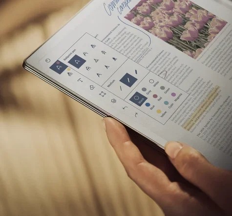 A person holds reMarkable Paper Pro displaying an annotated document in a manufacturer scene.